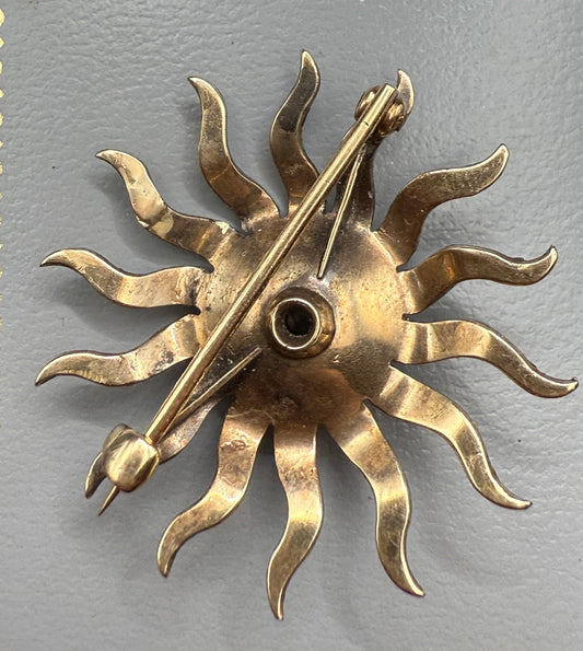 Back of gold starburst brooch with pin clasp, convertible to pendant