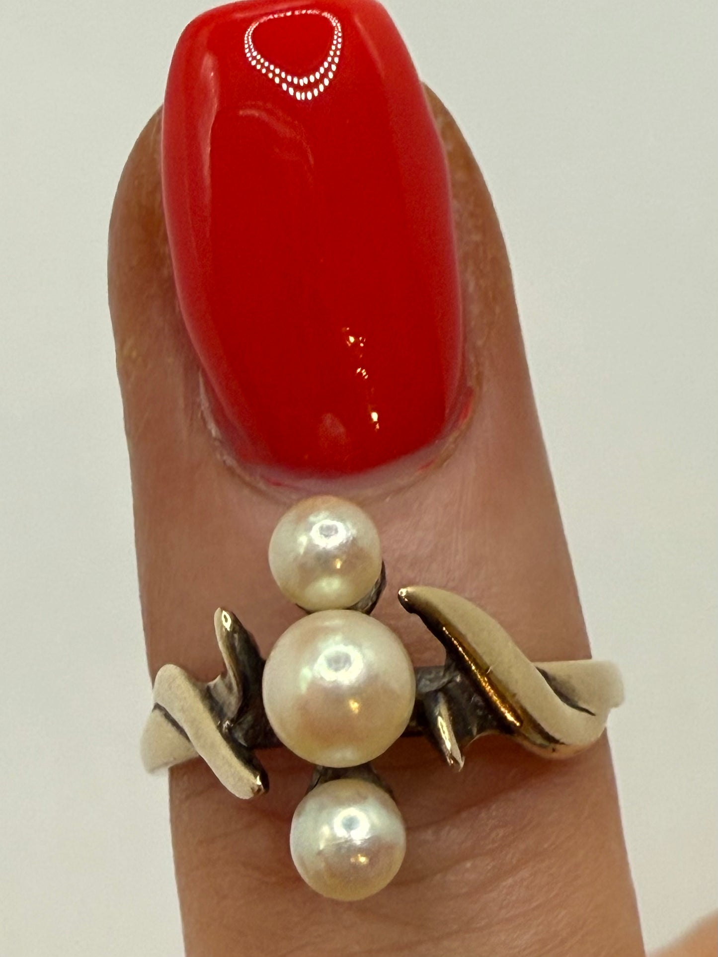 10K yellow gold three-pearl ring on finger