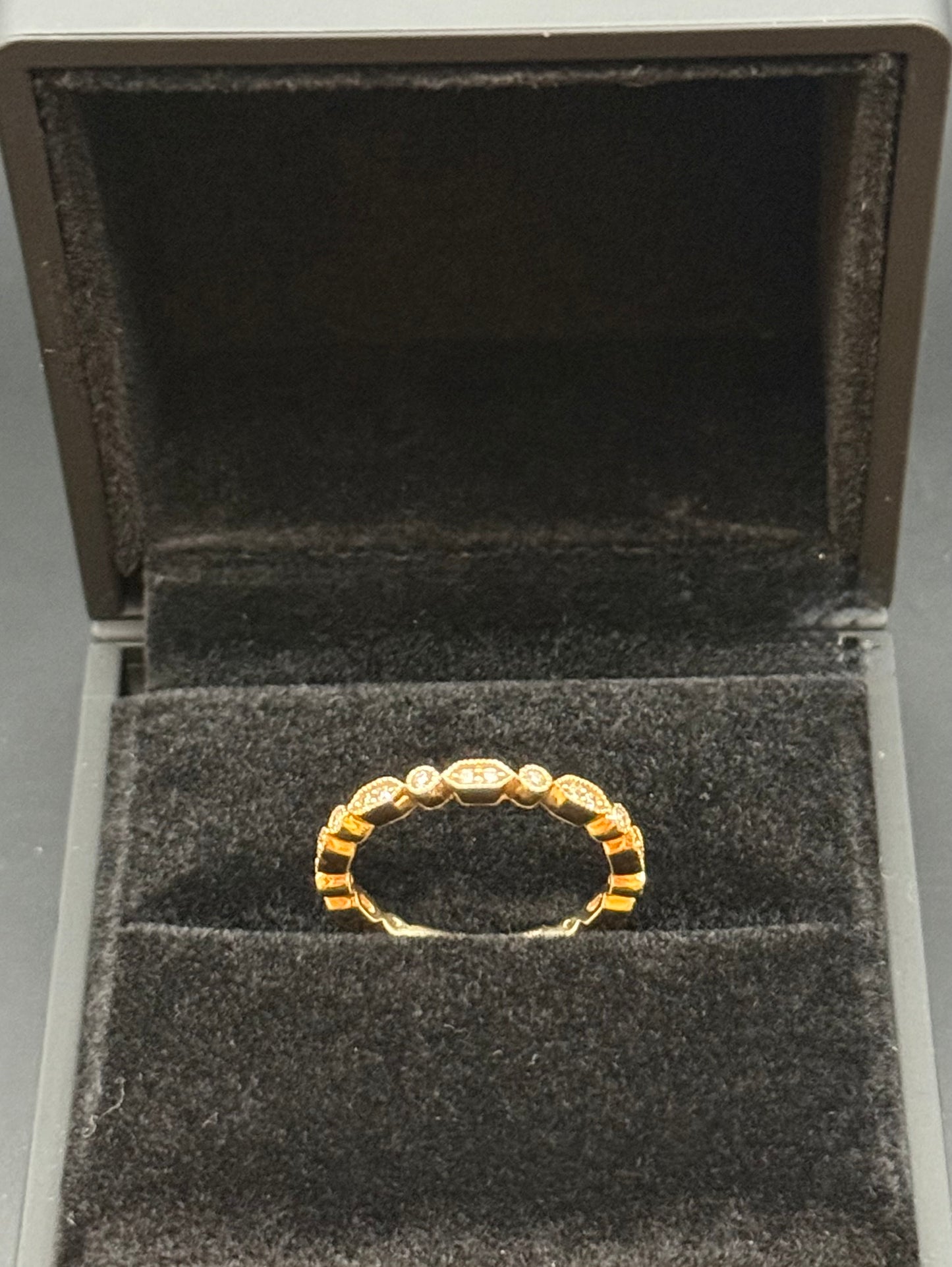 14K rosy yellow gold diamond eternity band ring on black velvet display