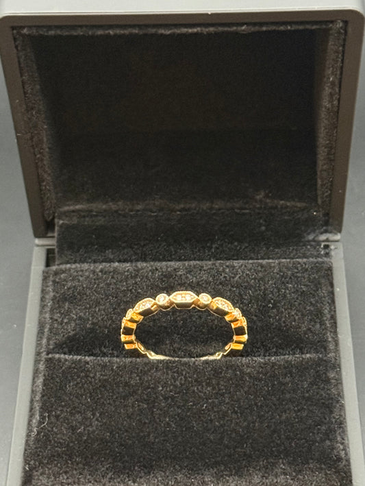 14K rosy yellow gold diamond eternity band ring on black velvet display