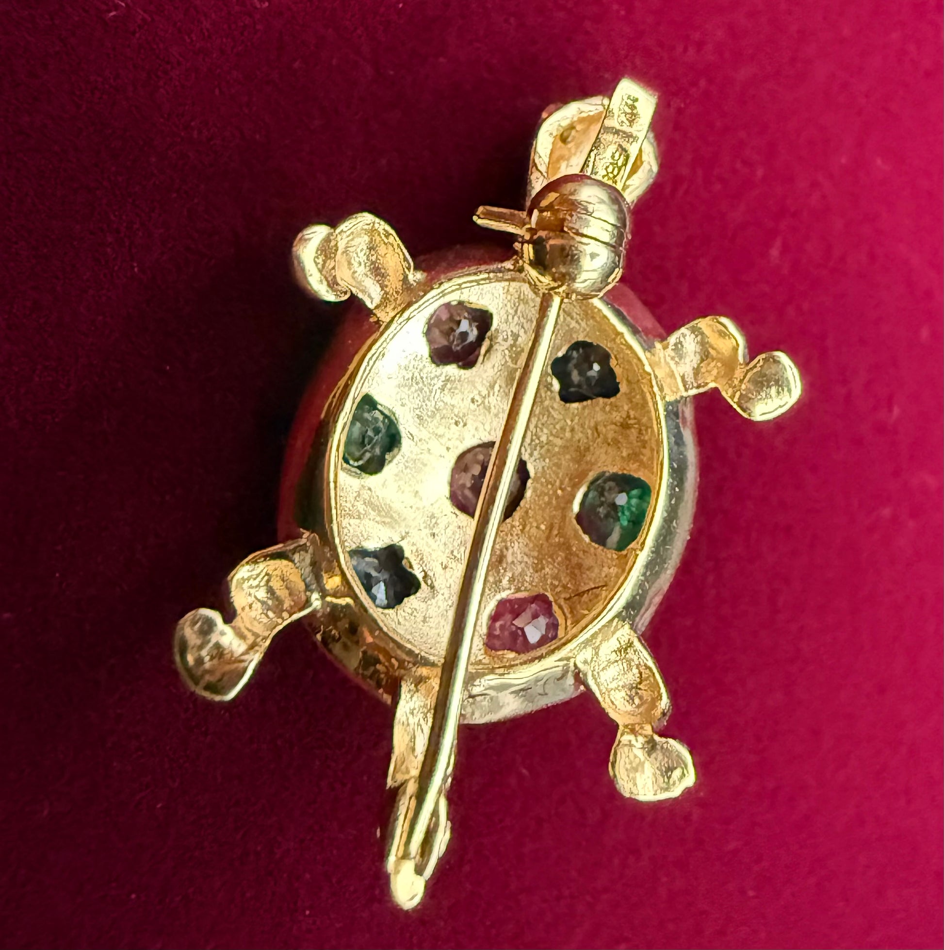 Back view showing pin clasp, bail, and hallmarks