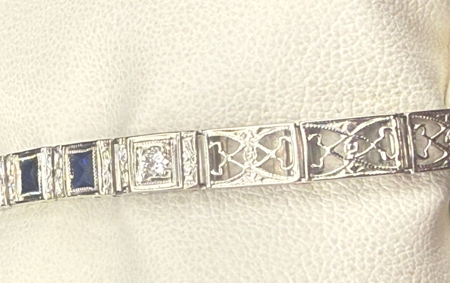 Close-up front view of 1920’s Art Deco filigree bracelet showing diamond and sapphire alternating pattern