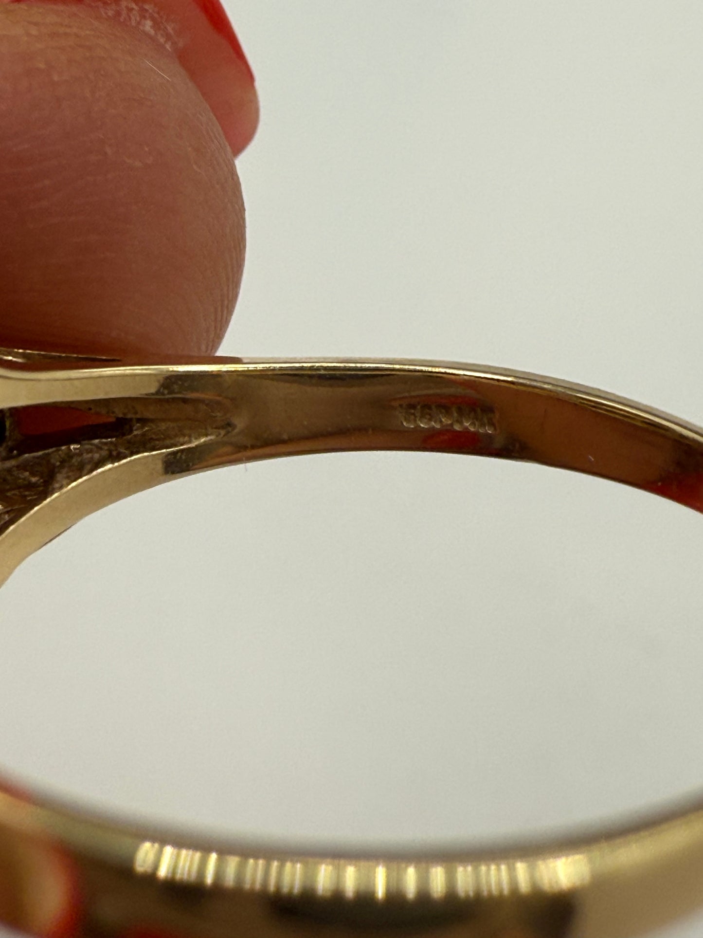 Close-up of 14K stamp inside ring shank (plum gold hallmark)