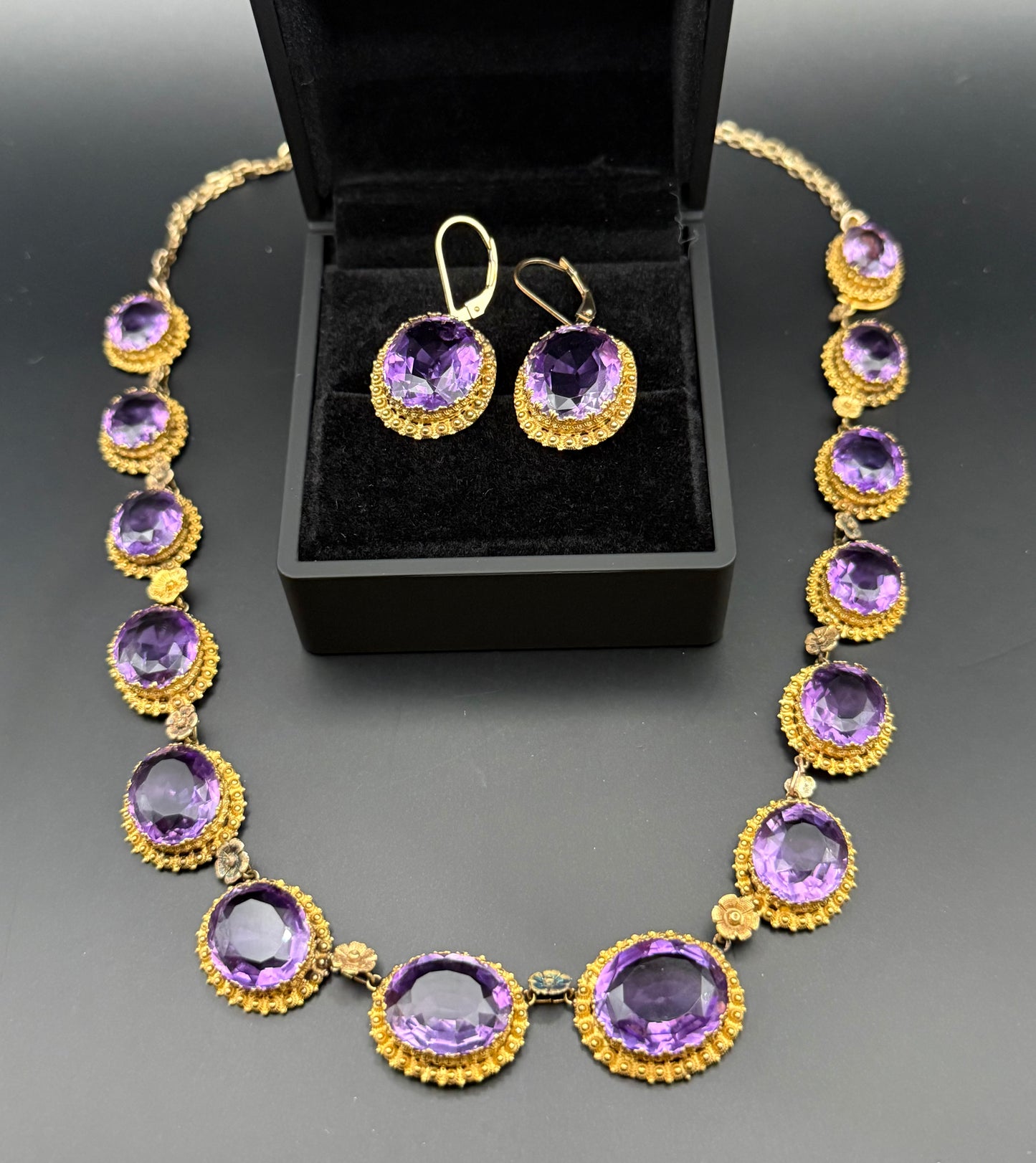 Close-up of Victorian amethyst and gold earrings in jewelry box