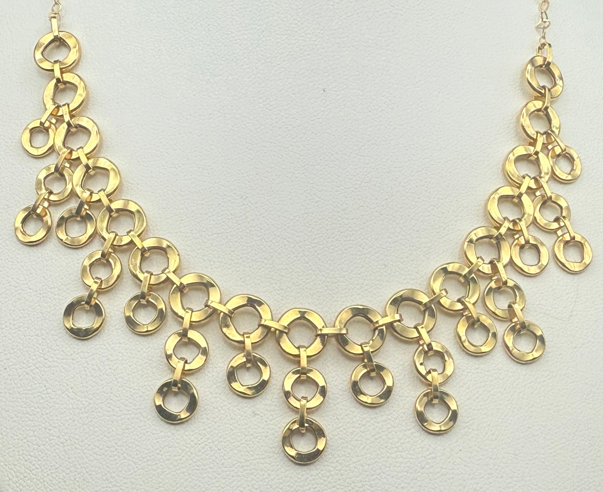 Close-up of cascading multi-link design in polished yellow gold