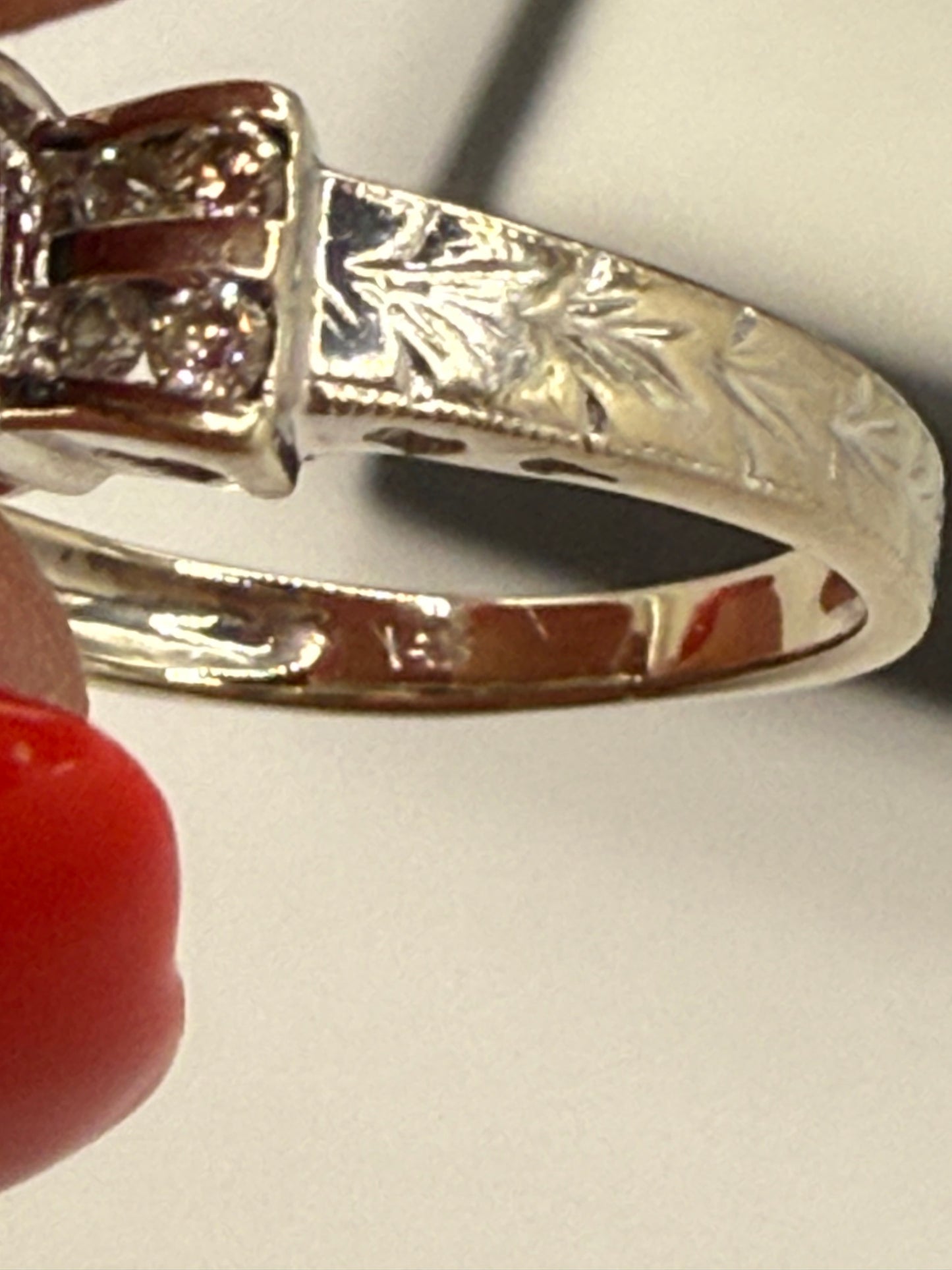Close-up of engraved floral pattern on 14K white gold band.