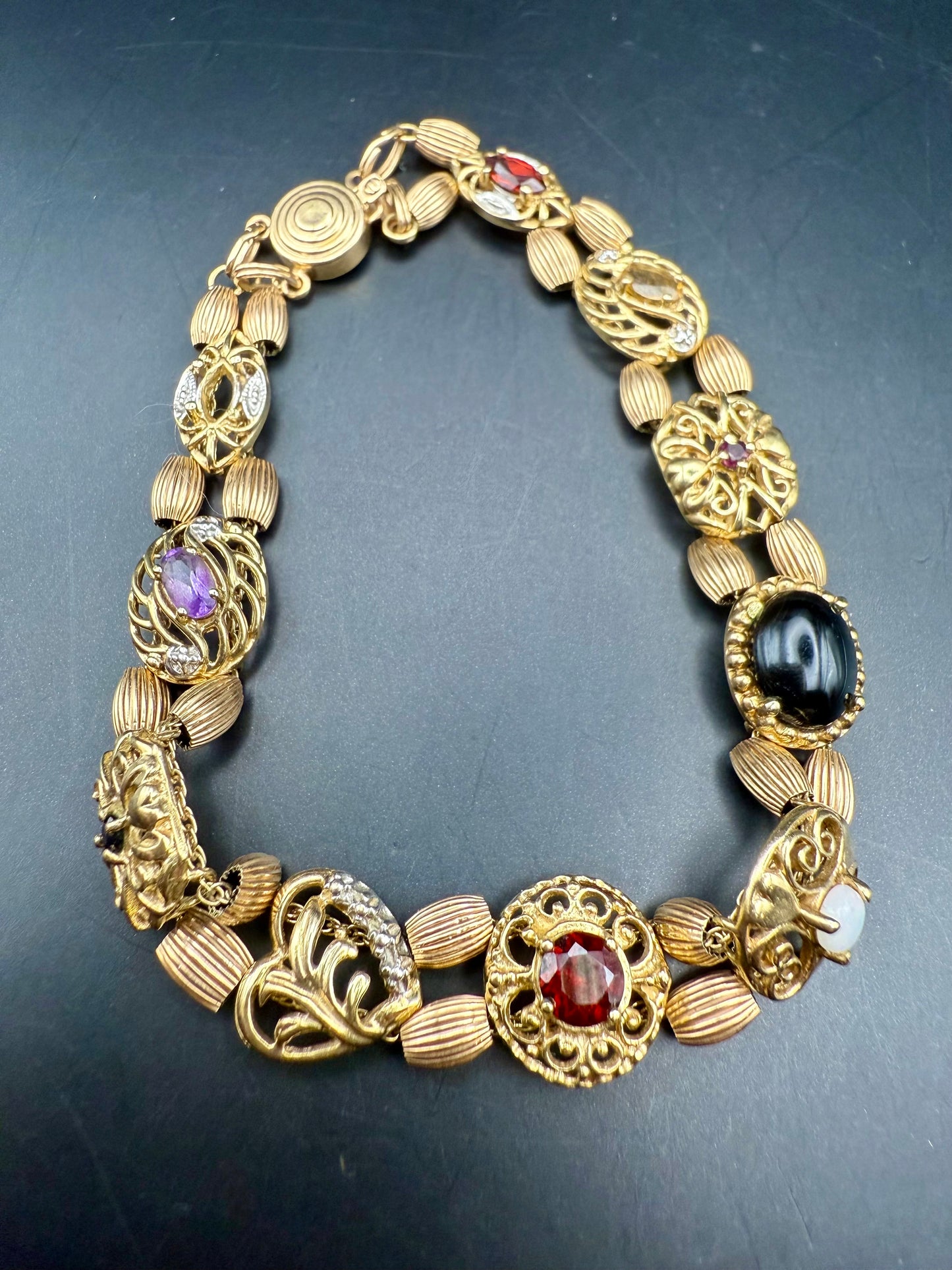 Close-up of gemstone details including garnet, opal, amethyst, and cameo