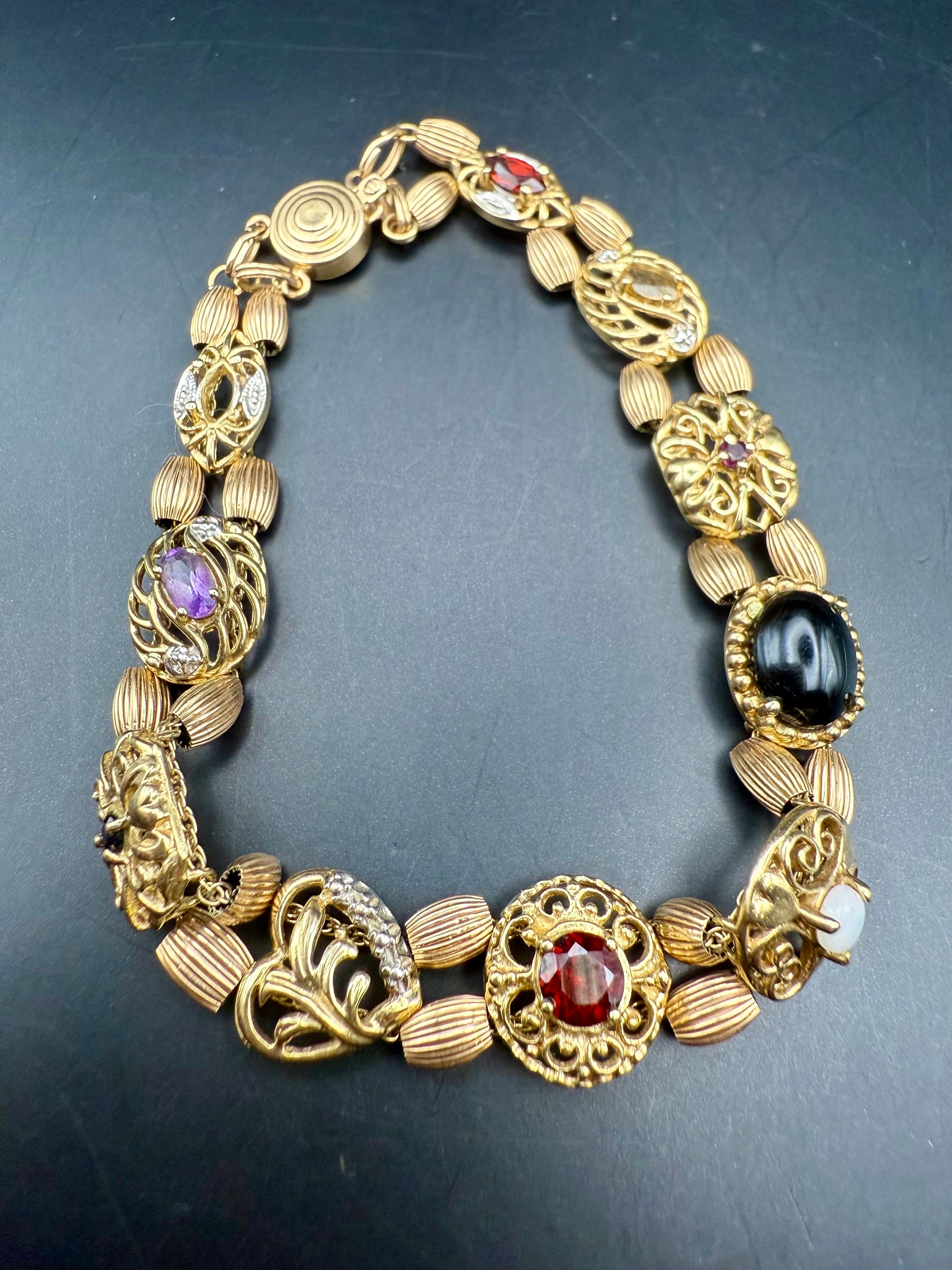 Close-up of gemstone details including garnet, opal, amethyst, and cameo