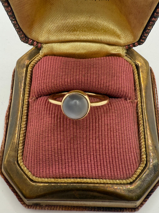 Close view of antique 10K gold moonstone ring in vintage red velvet jewelry box