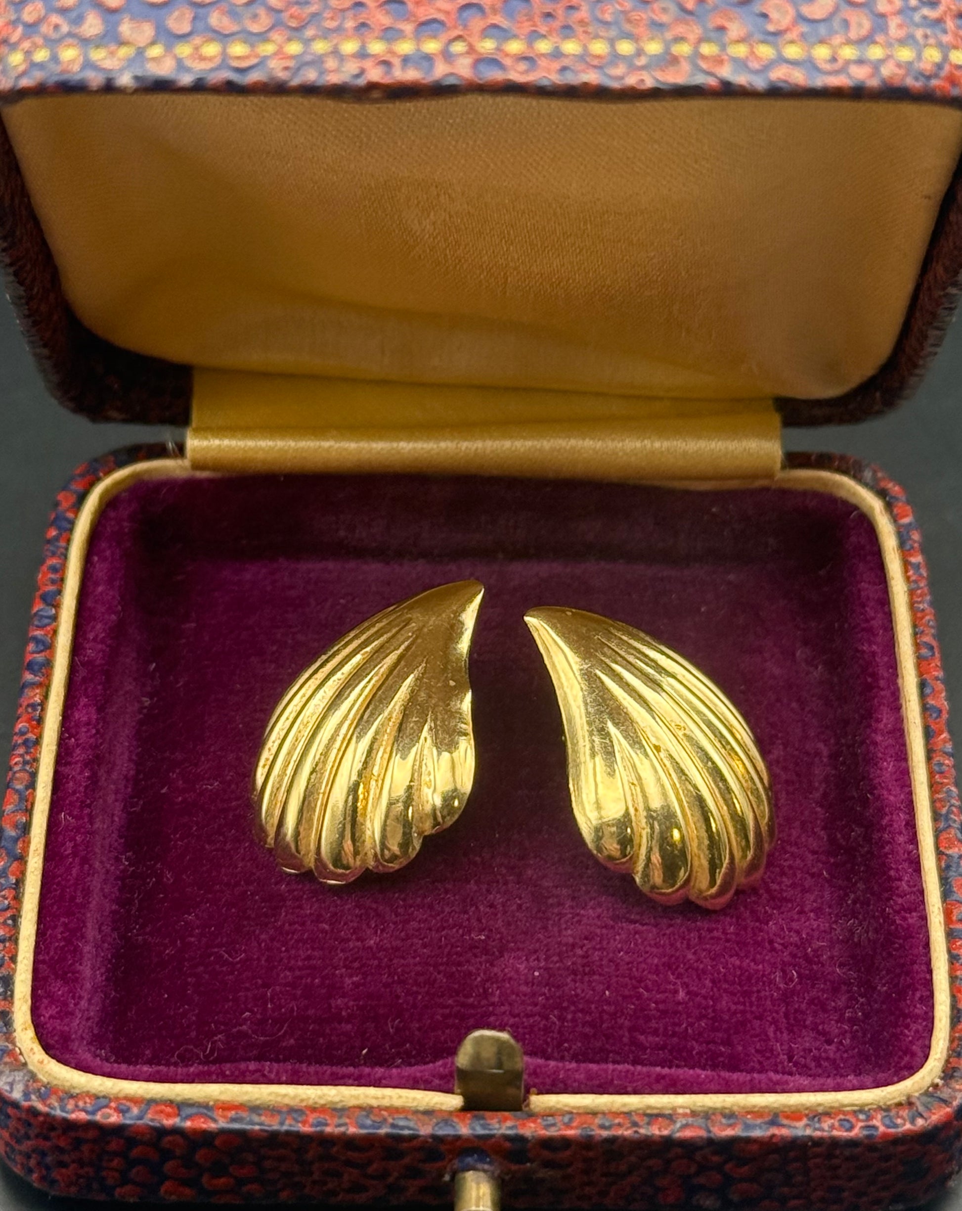 Earrings displayed in vintage velvet box with gold trim