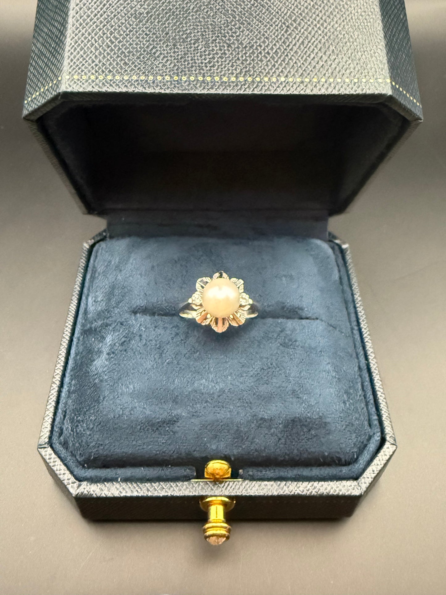 Estate 14K white gold pearl and diamond ring in vintage navy box, classic floral design with round pearl centerpiece.