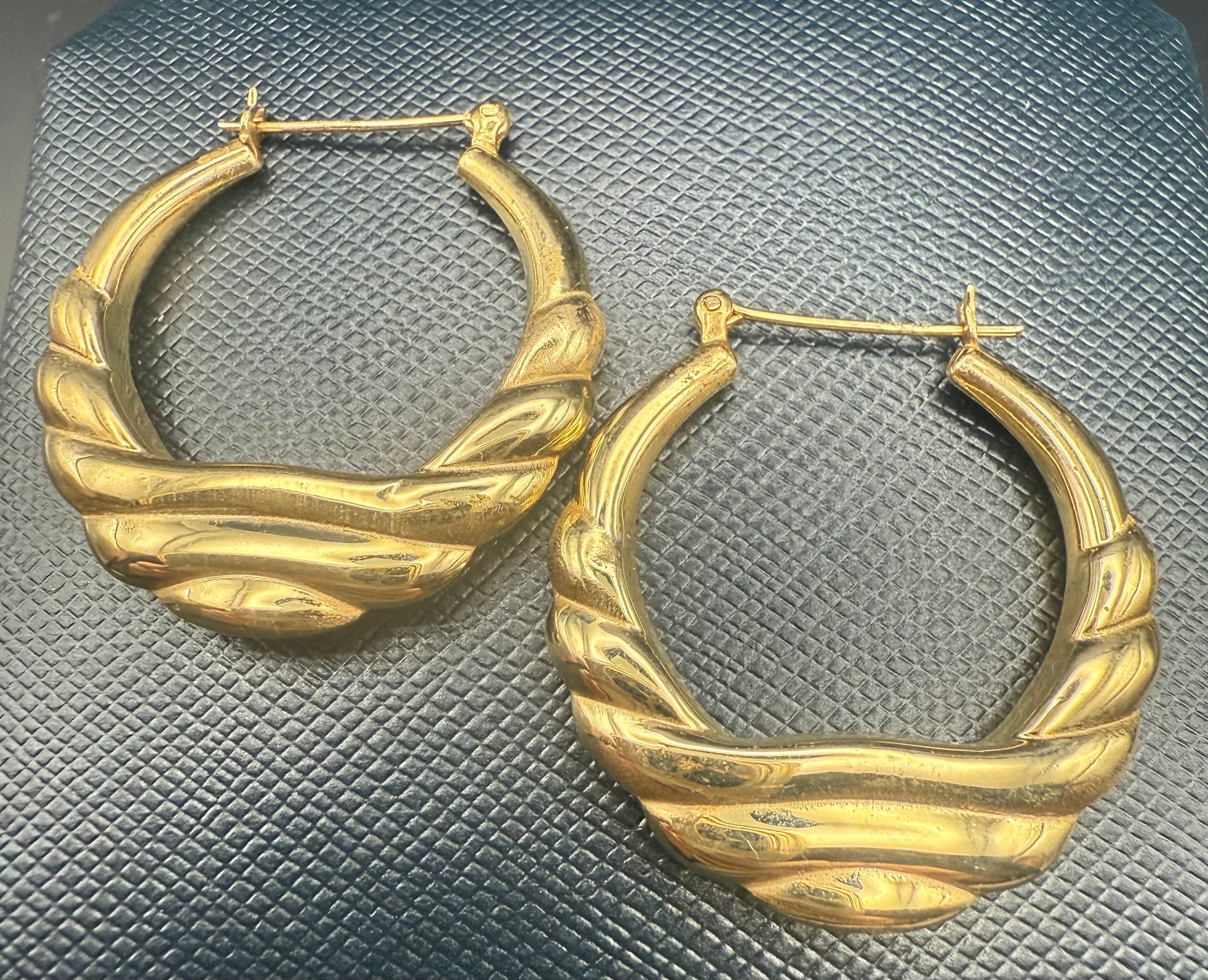Front view of vintage 14K gold puffy hoop earrings