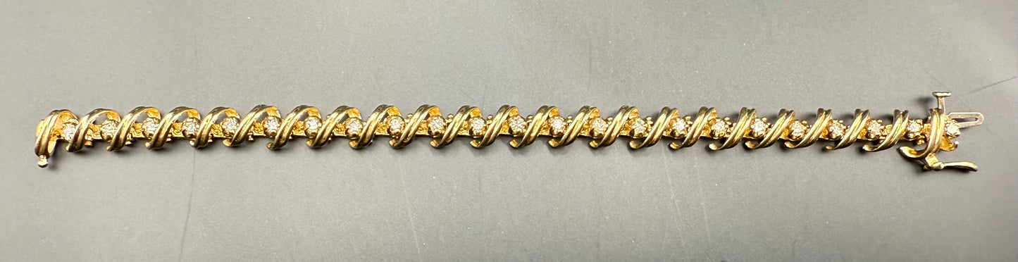 Full bracelet laid flat—continuous scroll loop design with diamonds