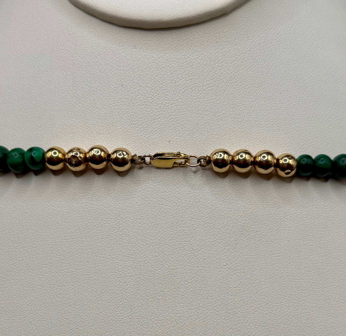 Graduated malachite necklace with central cabochon bead, 14k gold accents