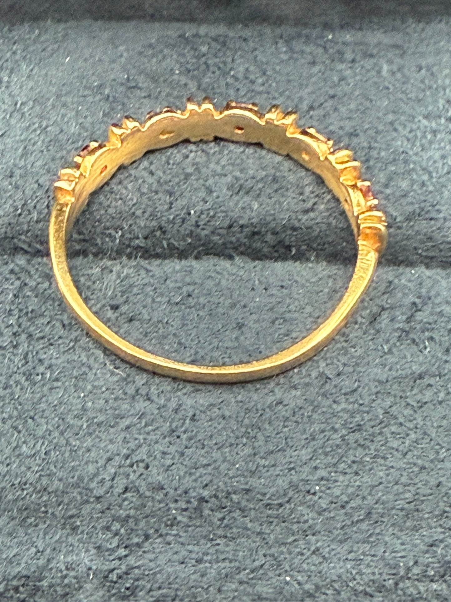 Inside view of vintage yellow gold band ring with alternating red and diamonds
