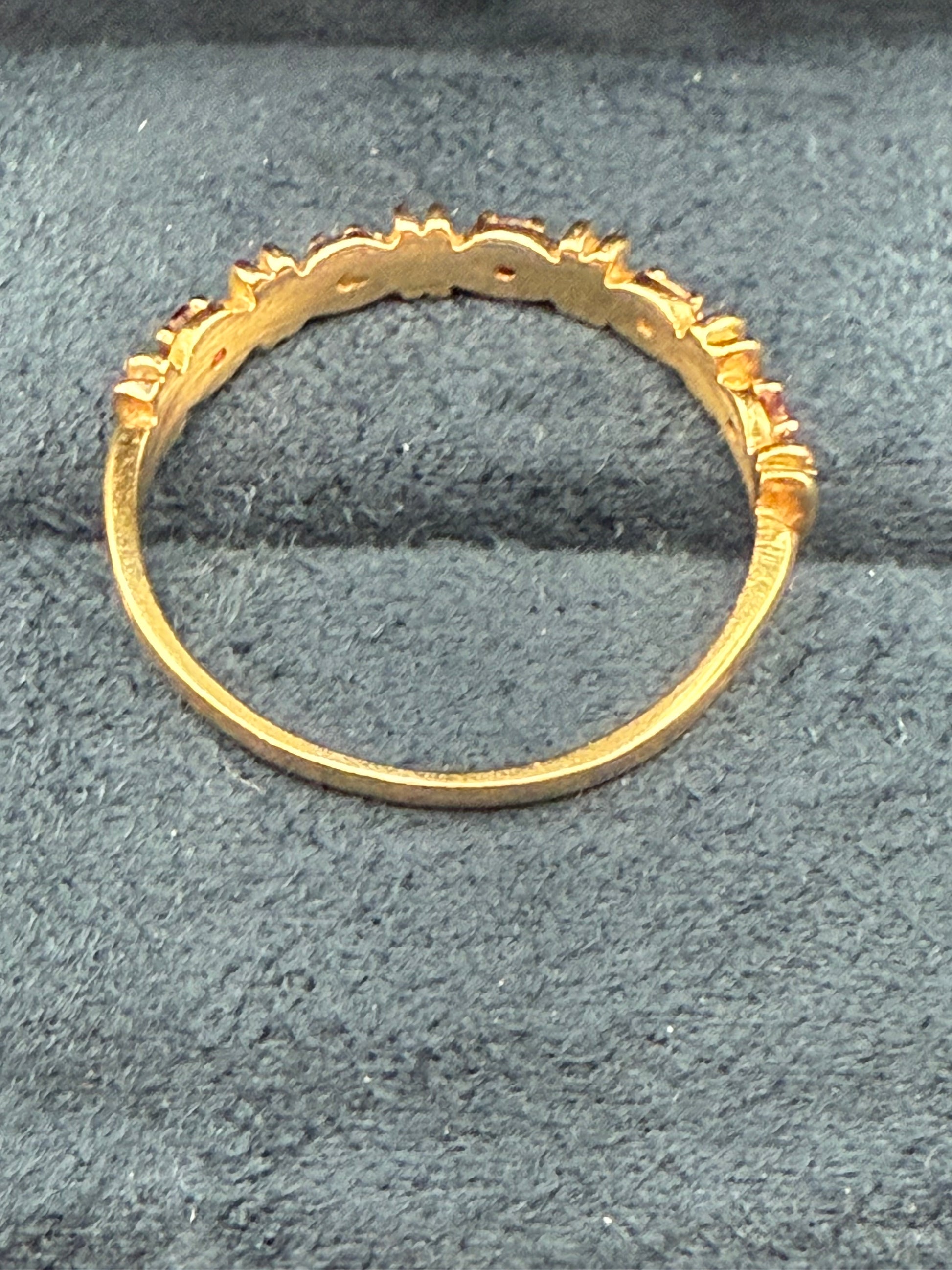 Inside view of vintage yellow gold band ring with alternating red and diamonds