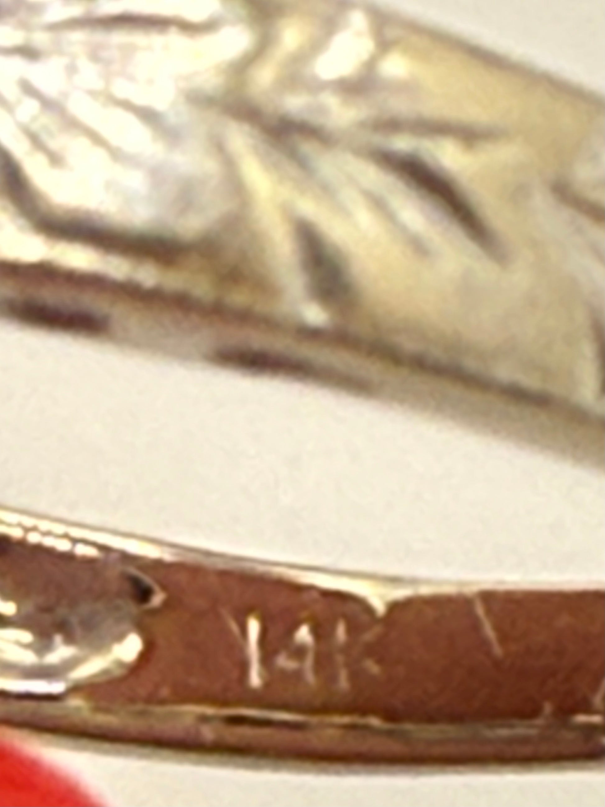 Macro photo of 14K stamp inside band confirming gold purity.