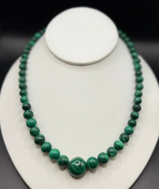 Modern estate 14k gold graduated malachite bead necklace displayed on stand