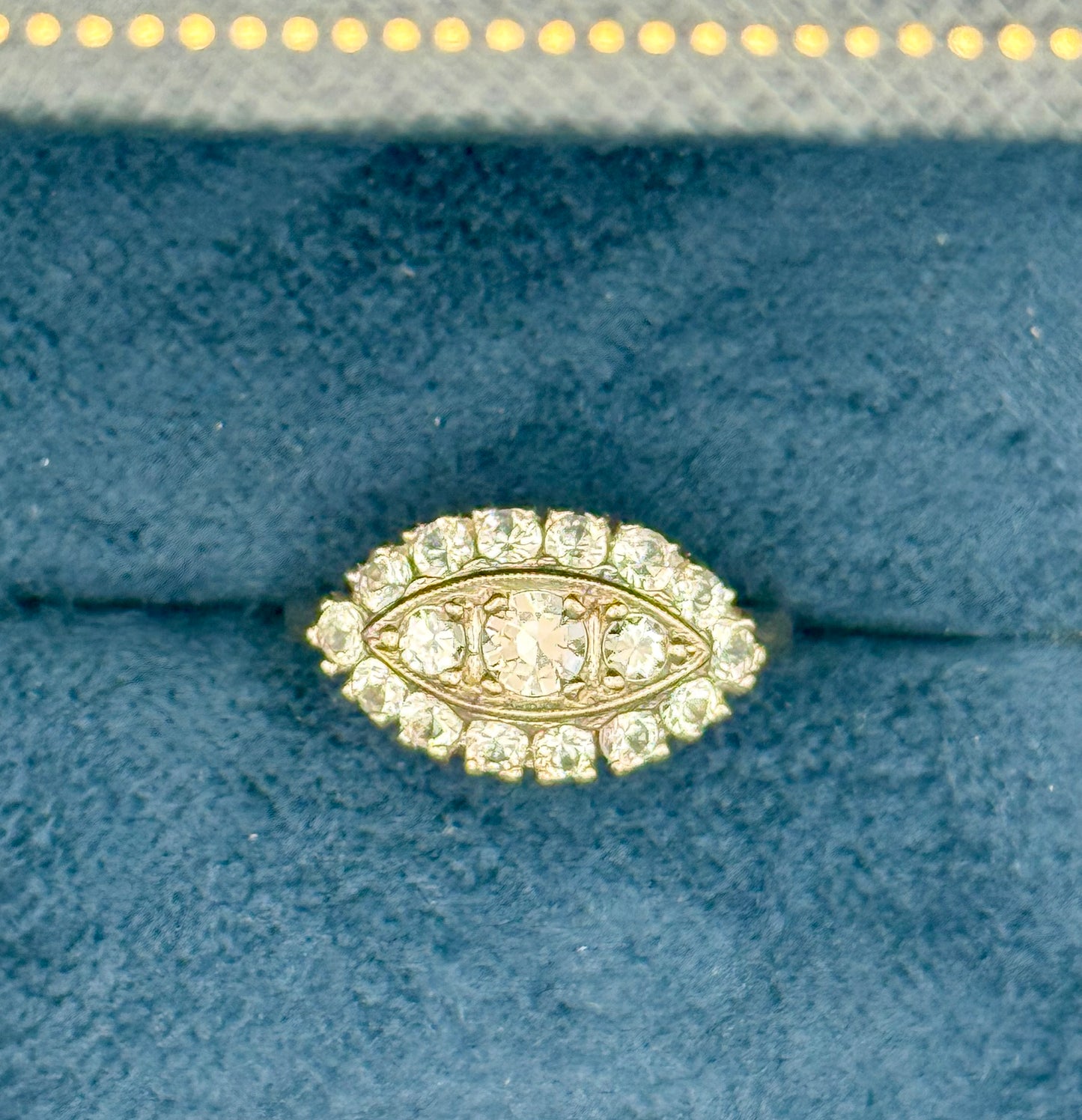 Overhead view of 1950s diamond halo ring with center stone surrounded by two halo rows.