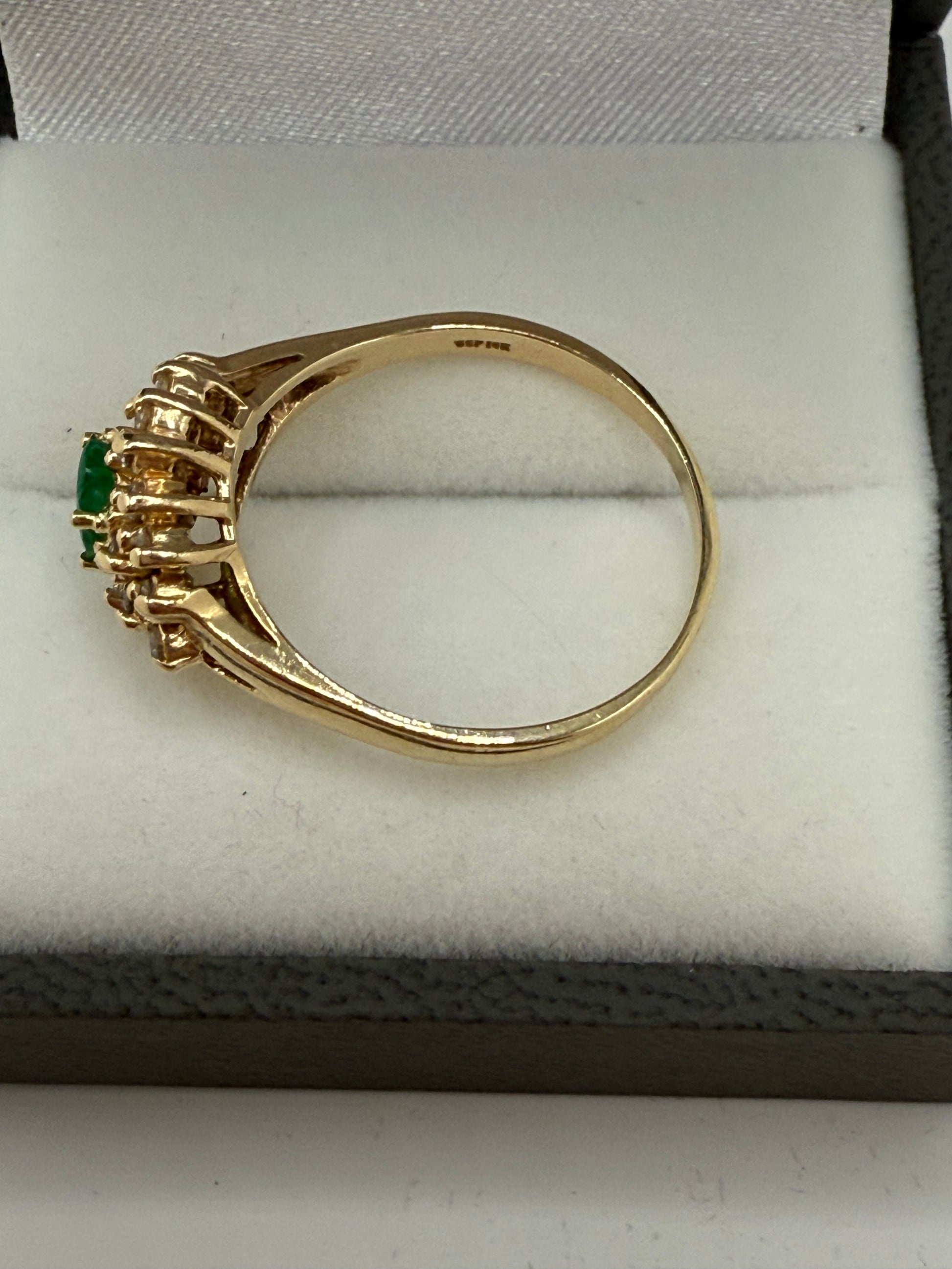 Side profile of 14K gold emerald and diamond cluster ring