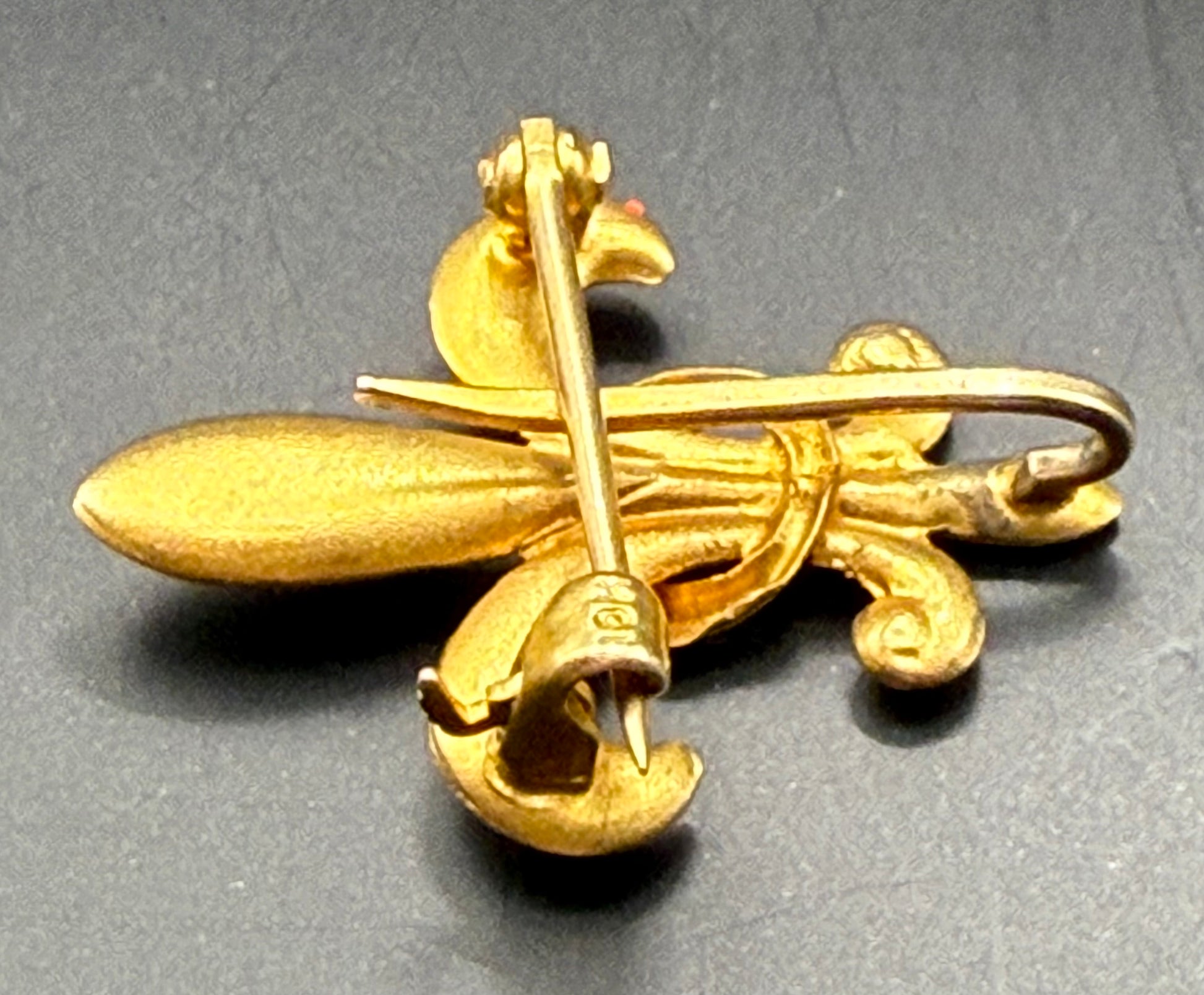 Side angle of Fleur-de-Lis brooch highlighting puffy crescent center and pin clasp