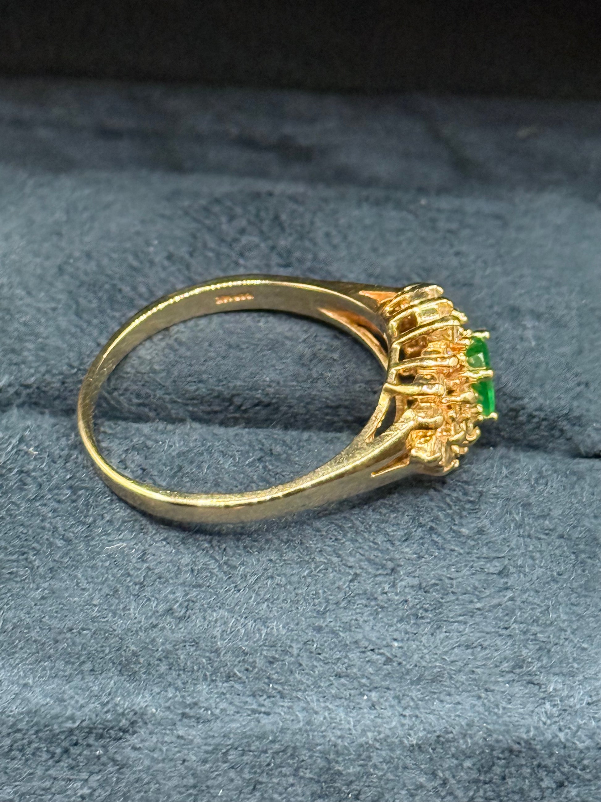 Side view of estate 14K yellow gold oval emerald and diamond cluster ring showing prong s