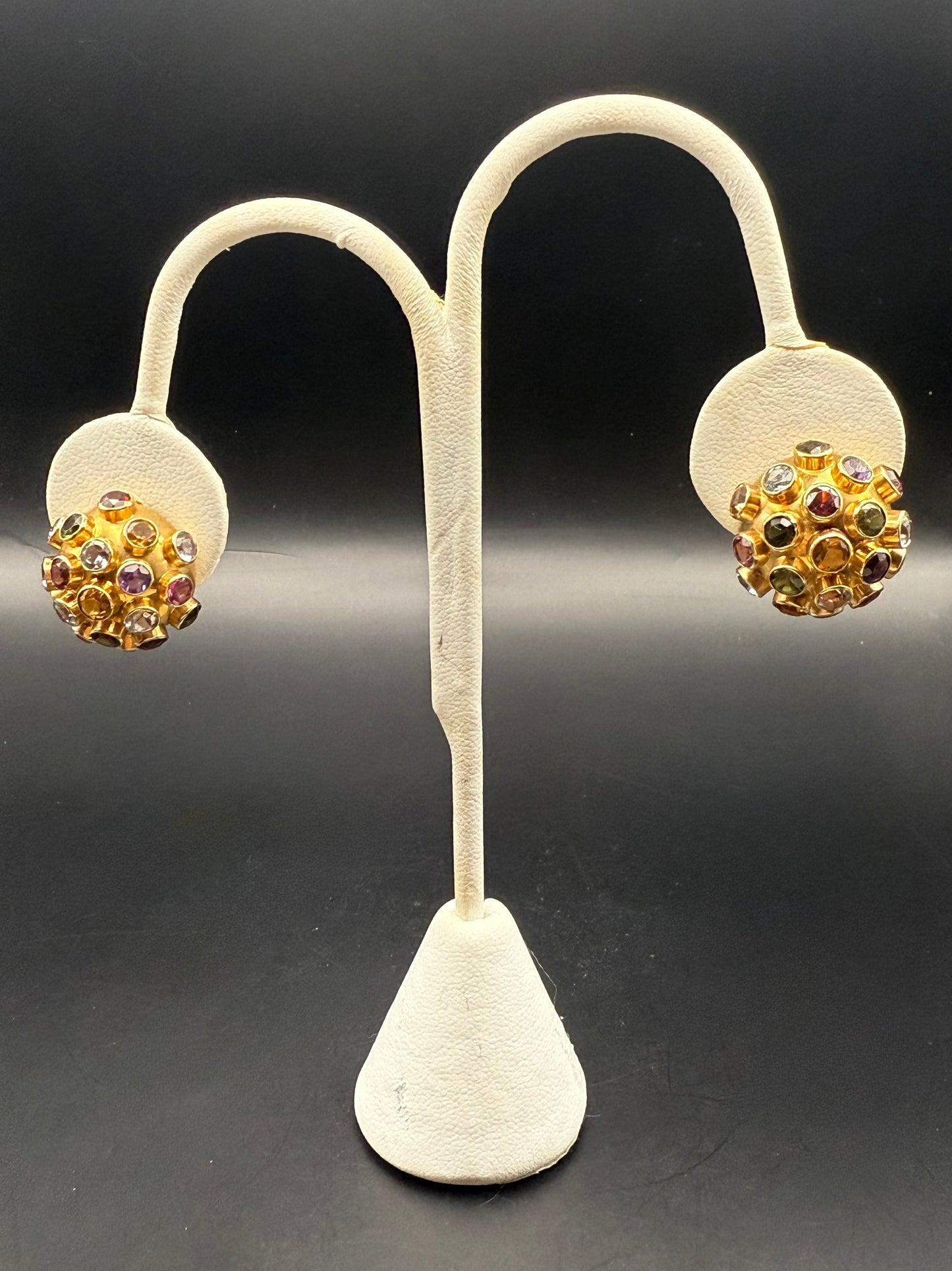 Sputnik earrings displayed on white earring stand