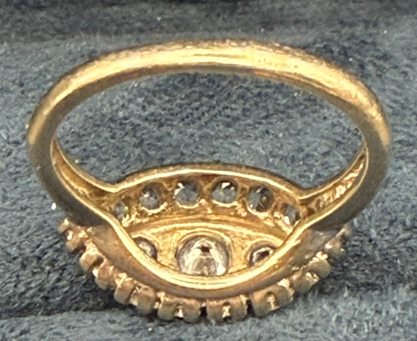 Underside of 1950s diamond ring highlighting openwork under-gallery and craftsmanship.