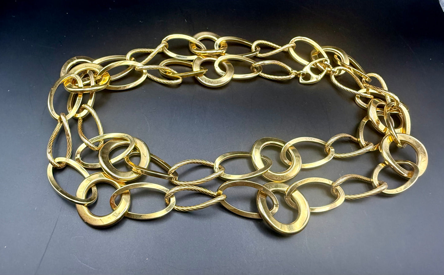 Vintage 14K yellow gold large link necklace coiled on black background