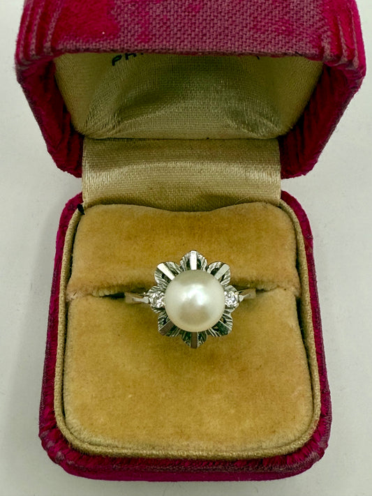 Vintage mid-century pearl and diamond ring in white gold, displayed in antique red velvet box.