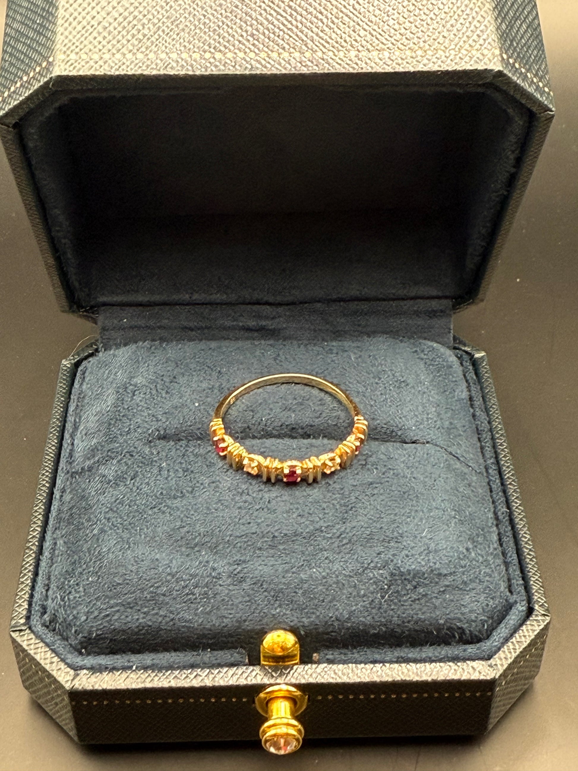 Vintage yellow gold band ring displayed in navy velvet presentation box