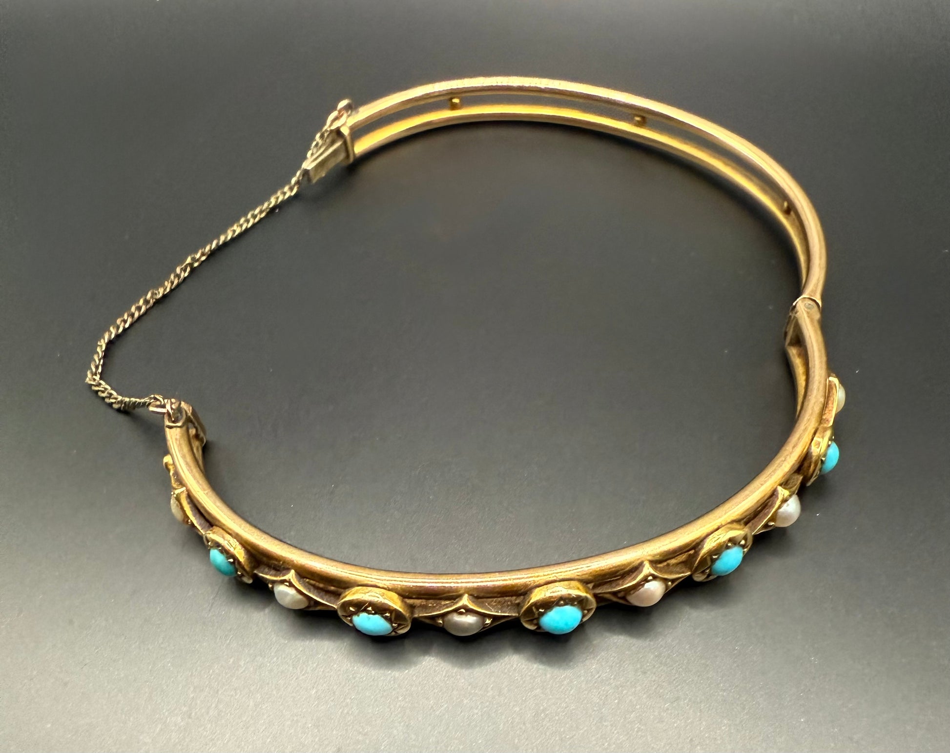 Victorian turquoise and pearl gold bangle bracelet open with safety chain visible